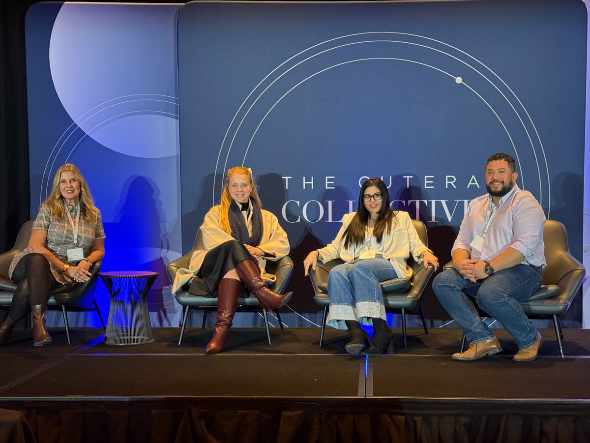Four people on a stage with a blue backdrop featuring 'The C uterus Collective' logo.